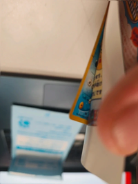 Additional angle showing the Marill card beneath the partially peeled backing.